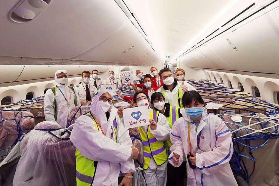 Plane interior with all passengers and crew in PPE