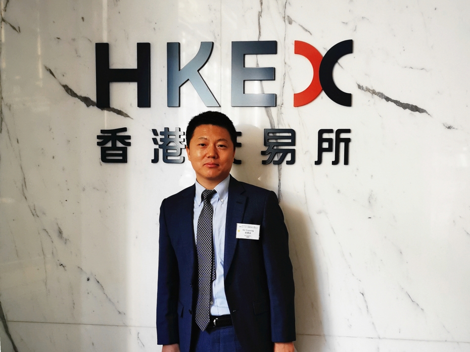 Yuexing Su with HKE backdrop