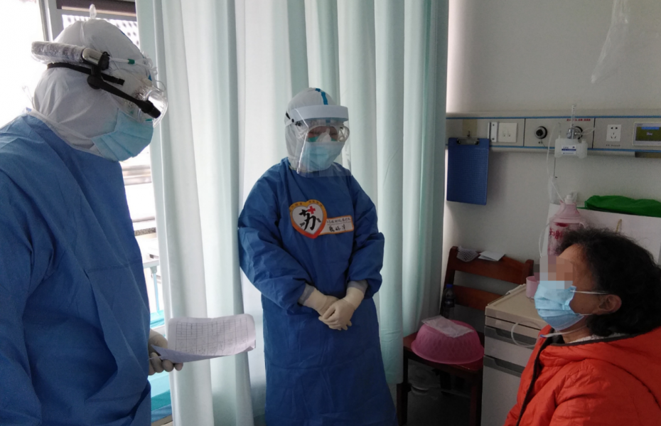 Medical ward patient and staff in PPE